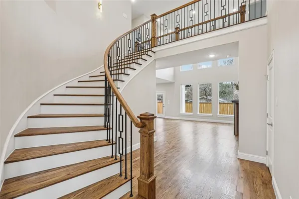 a view of entryway and hall with wooden floor