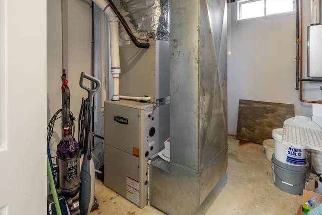 a view of a white house with a big yard and potted plants
