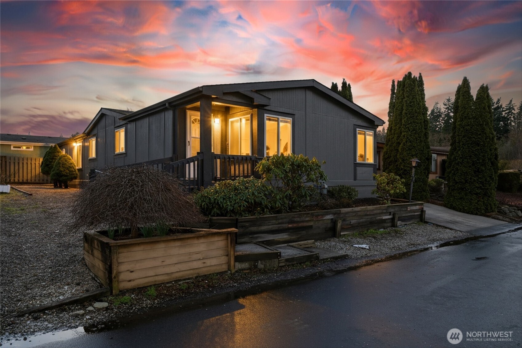 a front view of a house with a garden