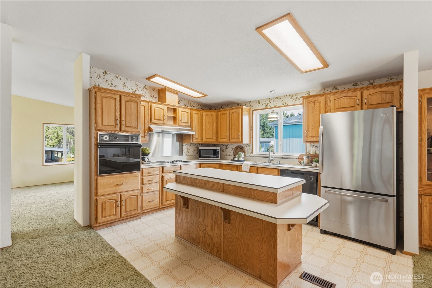 2015 24th Street, Unit 94 Bellingham, WA 98225 - Photo 13 of 40 a kitchen with stainless steel appliances granite countertop a refrigerator a stove a sink and a refrigerator