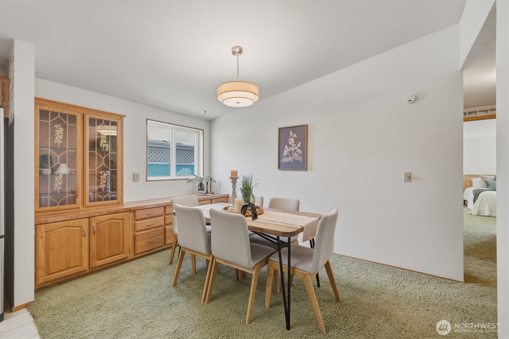 2015 24th Street, Unit 94 Bellingham, WA 98225 - Photo 15 of 40 a view of a dining room with furniture large windows and wooden floor