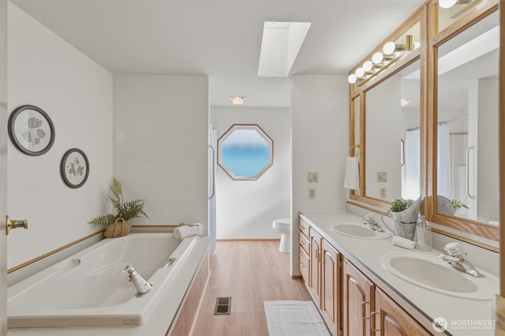2015 24th Street, Unit 94 Bellingham, WA 98225 - Photo 21 of 40 a spacious bathroom with a granite countertop sink and a large mirror