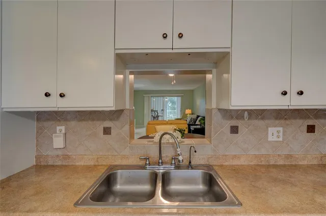 a kitchen with a sink and cabinets