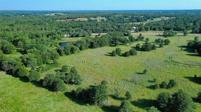 an aerial view of a house with yard