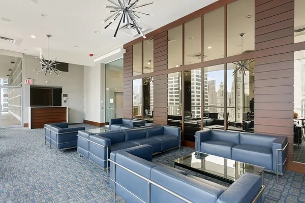 a living room with furniture flat screen tv and a large window