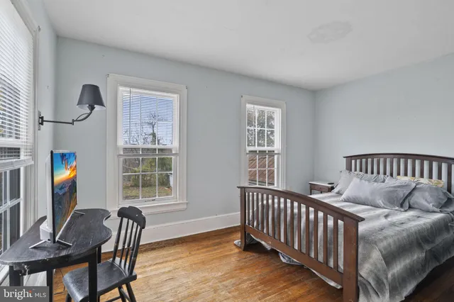 a spacious bedroom with a bed and a chandelier