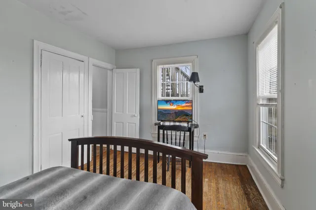 a bedroom with a bed a dresser and book shelf