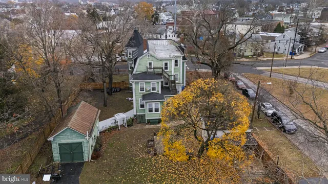 an aerial view of a brick house with a yard