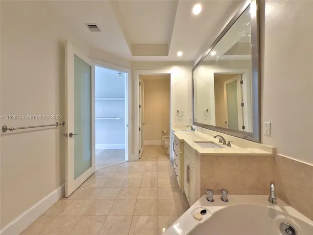 a bathroom with a shower and a glass door