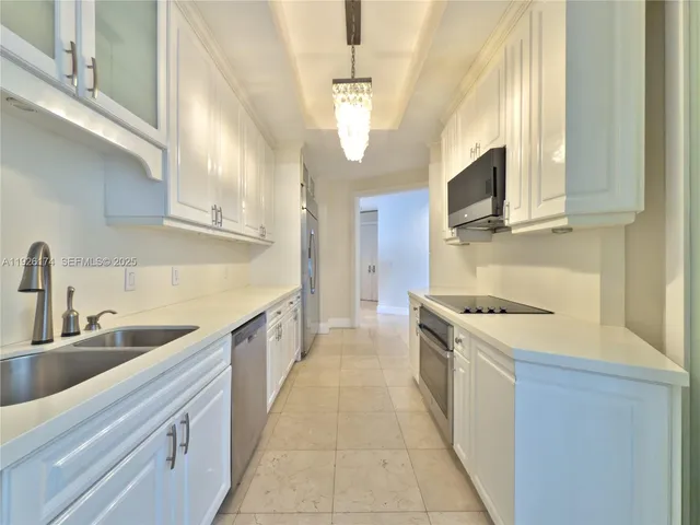 a kitchen with white cabinets and white appliances