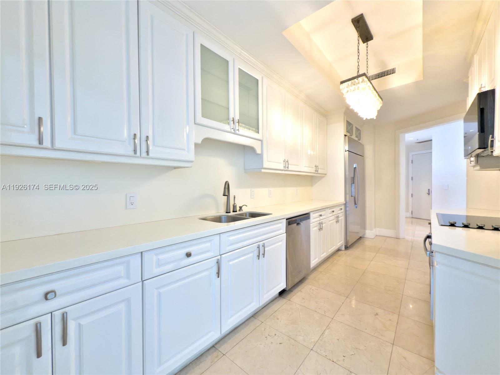 848 Brickell Key Drive, Unit 306 Miami, FL 33131 - Photo 26 of 66 a kitchen with cabinets and window