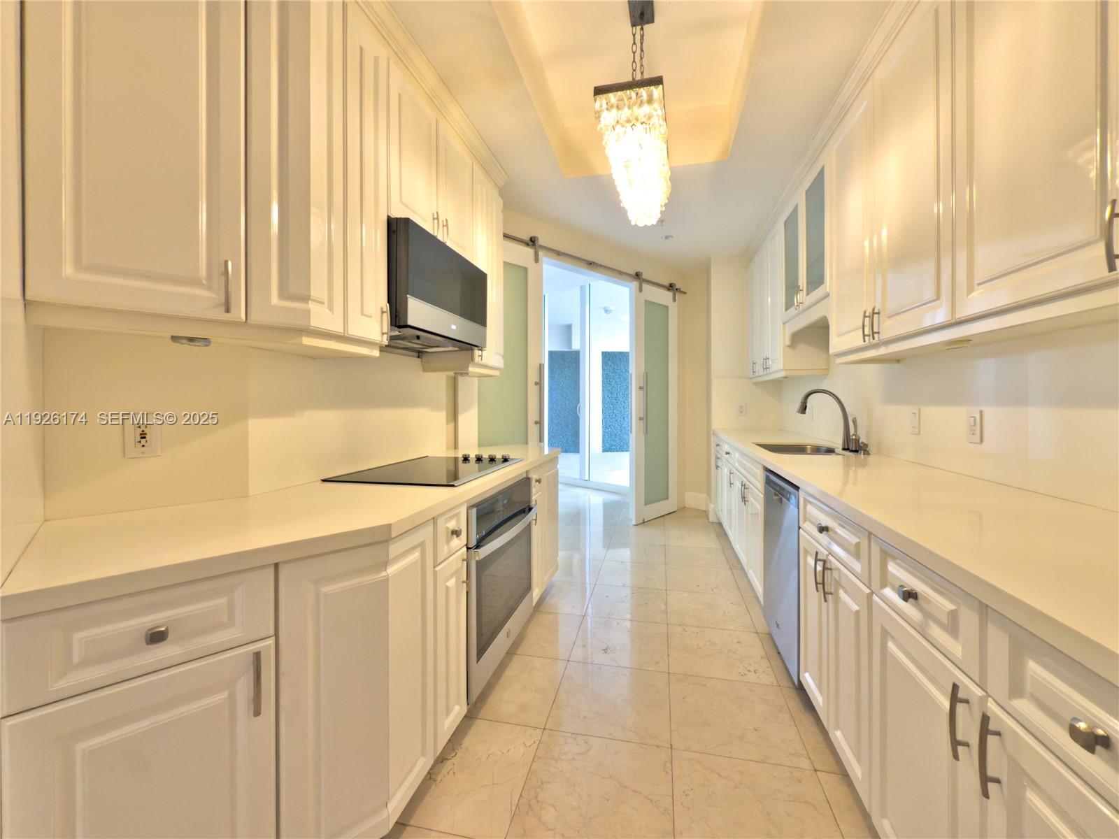 848 Brickell Key Drive, Unit 306 Miami, FL 33131 - Photo 28 of 66 a kitchen with stainless steel appliances granite countertop a sink and dishwasher a stove with wooden floor