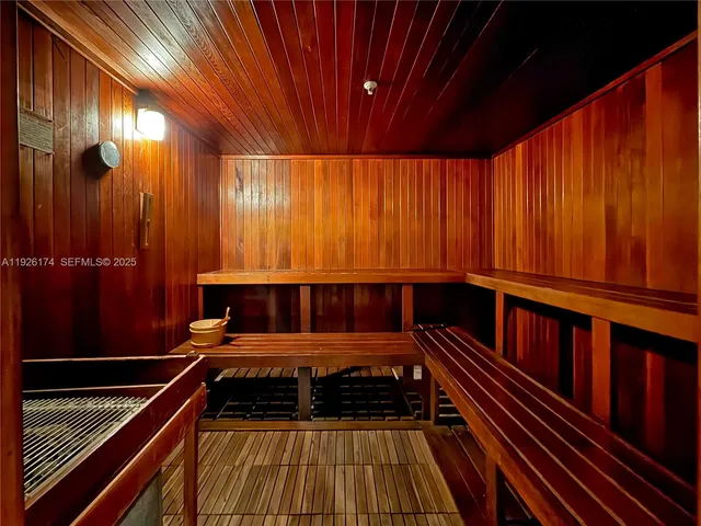 a living room with a large window and furniture