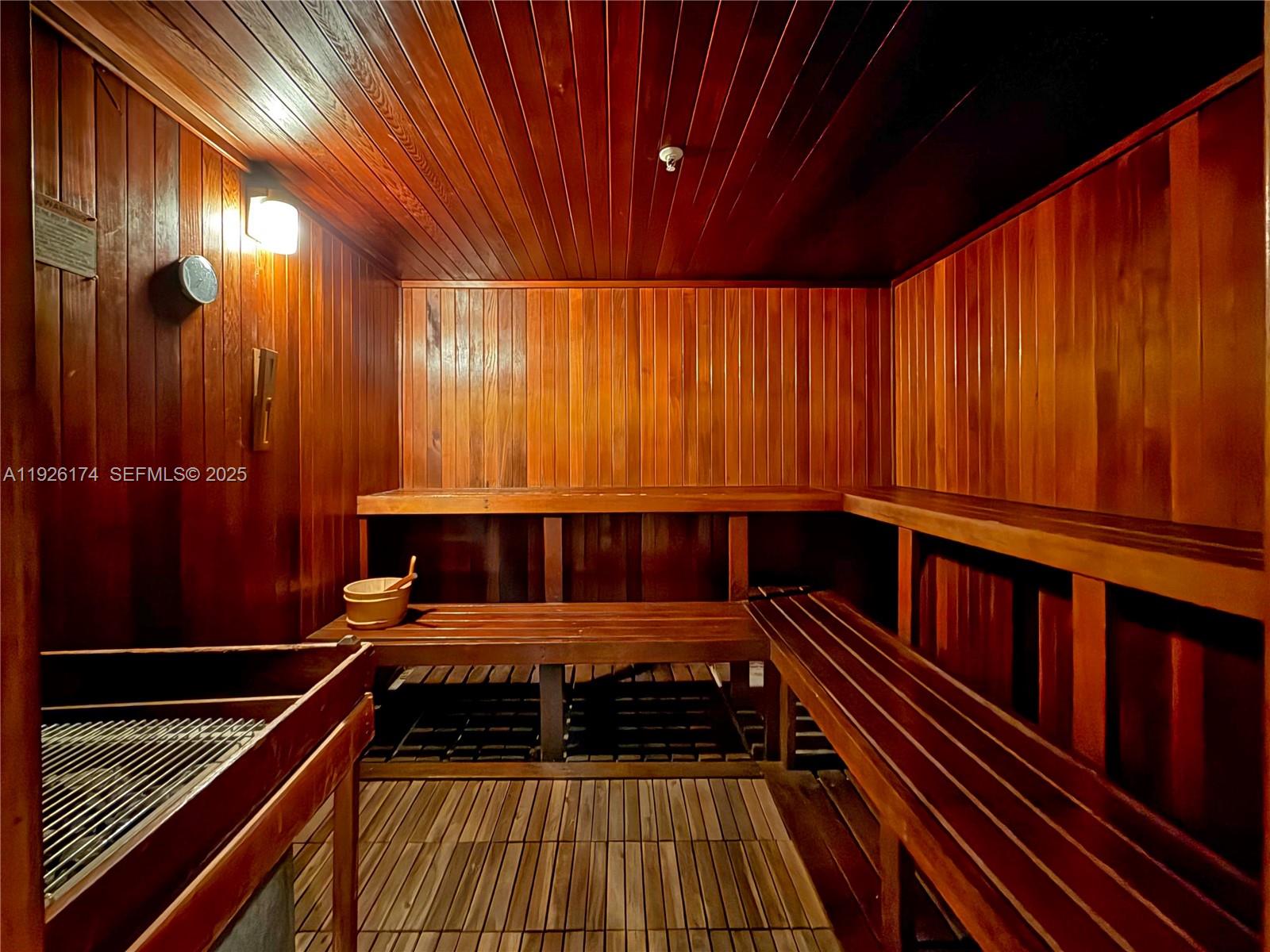 848 Brickell Key Drive, Unit 306 Miami, FL 33131 - Photo 42 of 66 a room with wooden floor and furniture