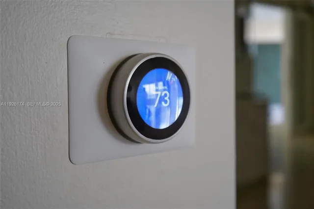 a dining room with furniture and a floor to ceiling window