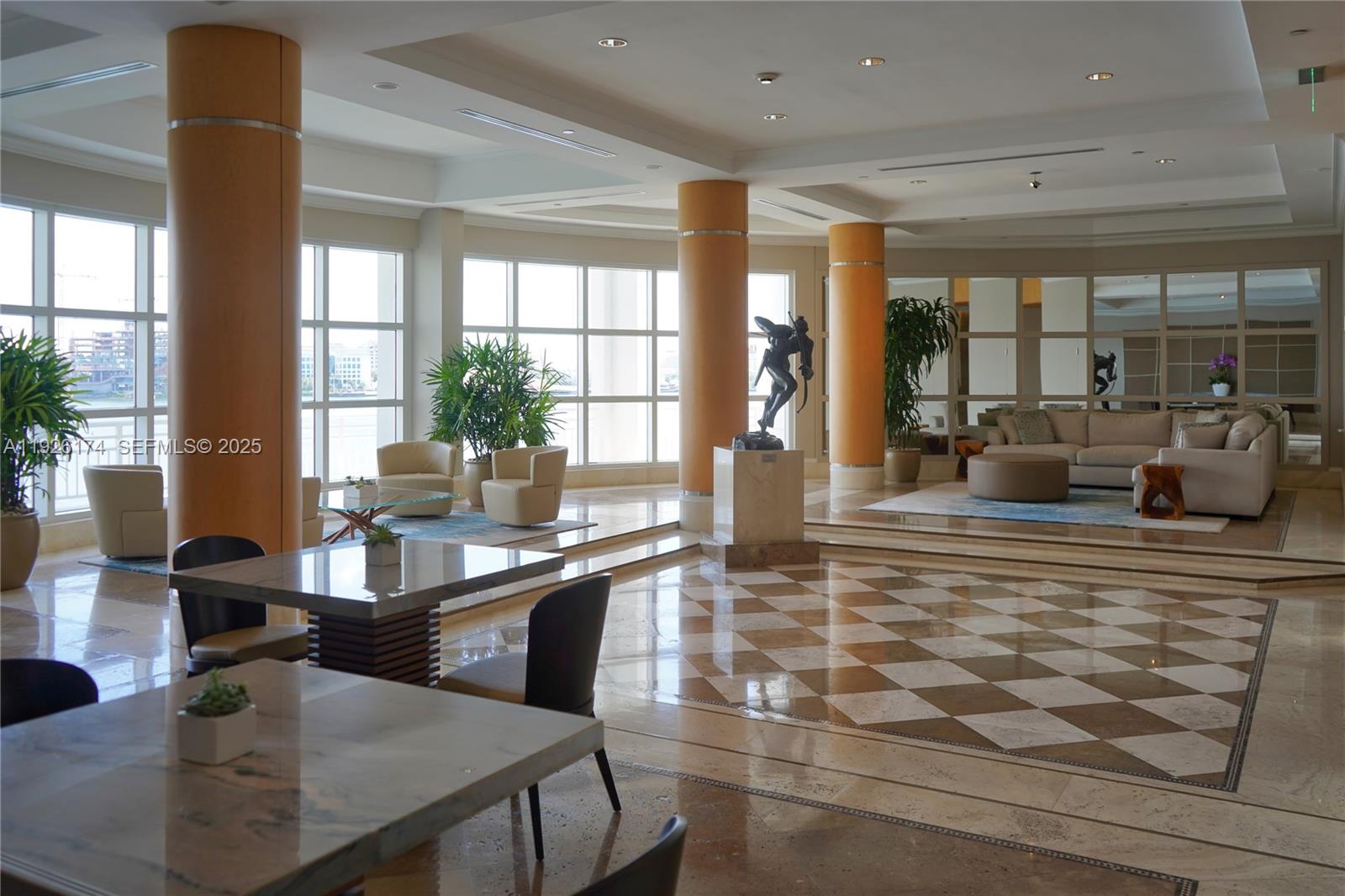 848 Brickell Key Drive, Unit 306 Miami, FL 33131 - Photo 65 of 66 a dining hall with stainless steel appliances granite countertop a dining table and chairs with wooden floor