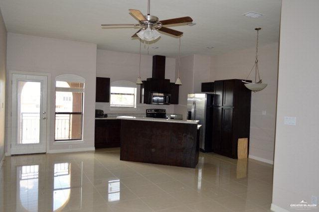2705 Mimosa Street, Unit 7 Mission, TX 78574 - Photo 2 of 9 a kitchen with stainless steel appliances granite countertop a refrigerator a stove and a granite counter tops