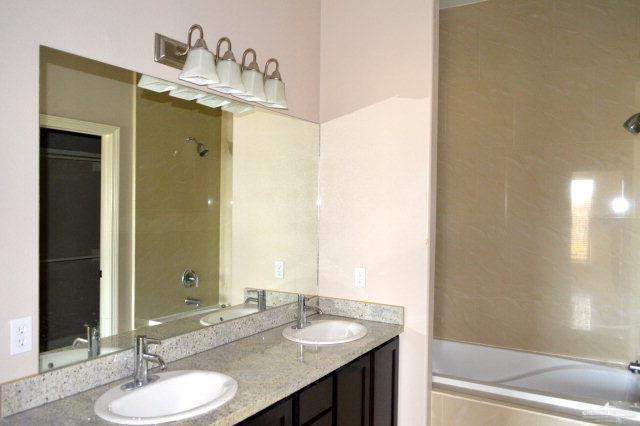 2705 Mimosa Street, Unit 7 Mission, TX 78574 - Photo 4 of 9 a bathroom with a granite countertop sink and a mirror