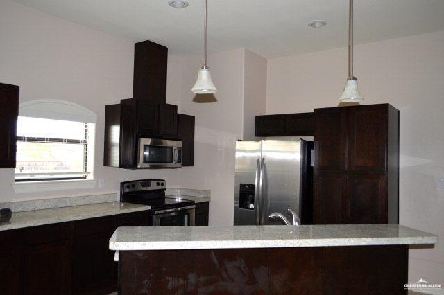 2705 Mimosa Street, Unit 7 Mission, TX 78574 - Photo 8 of 9 a kitchen with a refrigerator and a sink