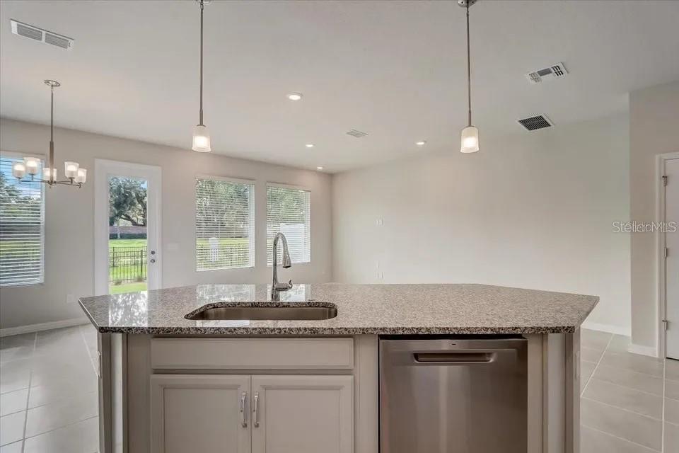 1851 Terrapin Road Ocoee, FL 34761 - Photo 7 of 22 a kitchen with granite countertop a sink cabinets and window