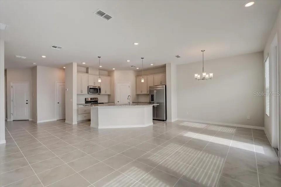 1851 Terrapin Road Ocoee, FL 34761 - Photo 9 of 22 a view of kitchen with kitchen island stainless steel appliances refrigerator sink and cabinets