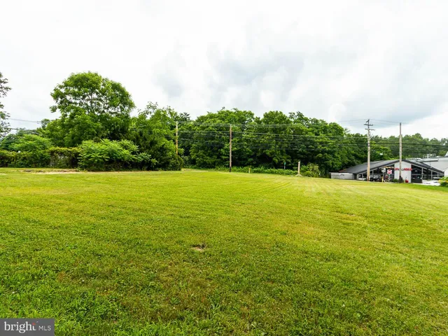 a view of outdoor space with swimming pool and green space