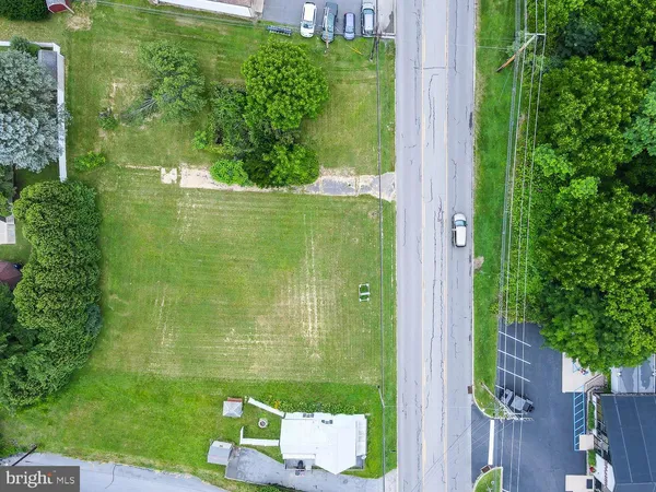 an aerial view of residential houses with outdoor space and street view
