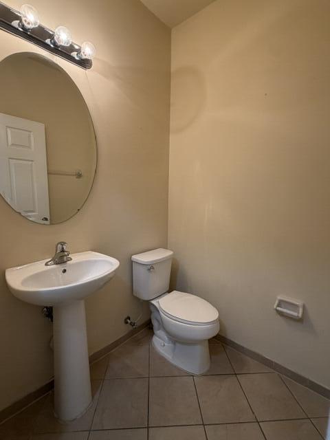 23765 Southwest 118 Avenue, Unit 23765 Homestead, FL 33032 - Photo 9 of 36 a bathroom with a toilet a sink and mirror
