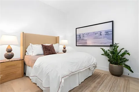 a bed room with a bed and a potted plant