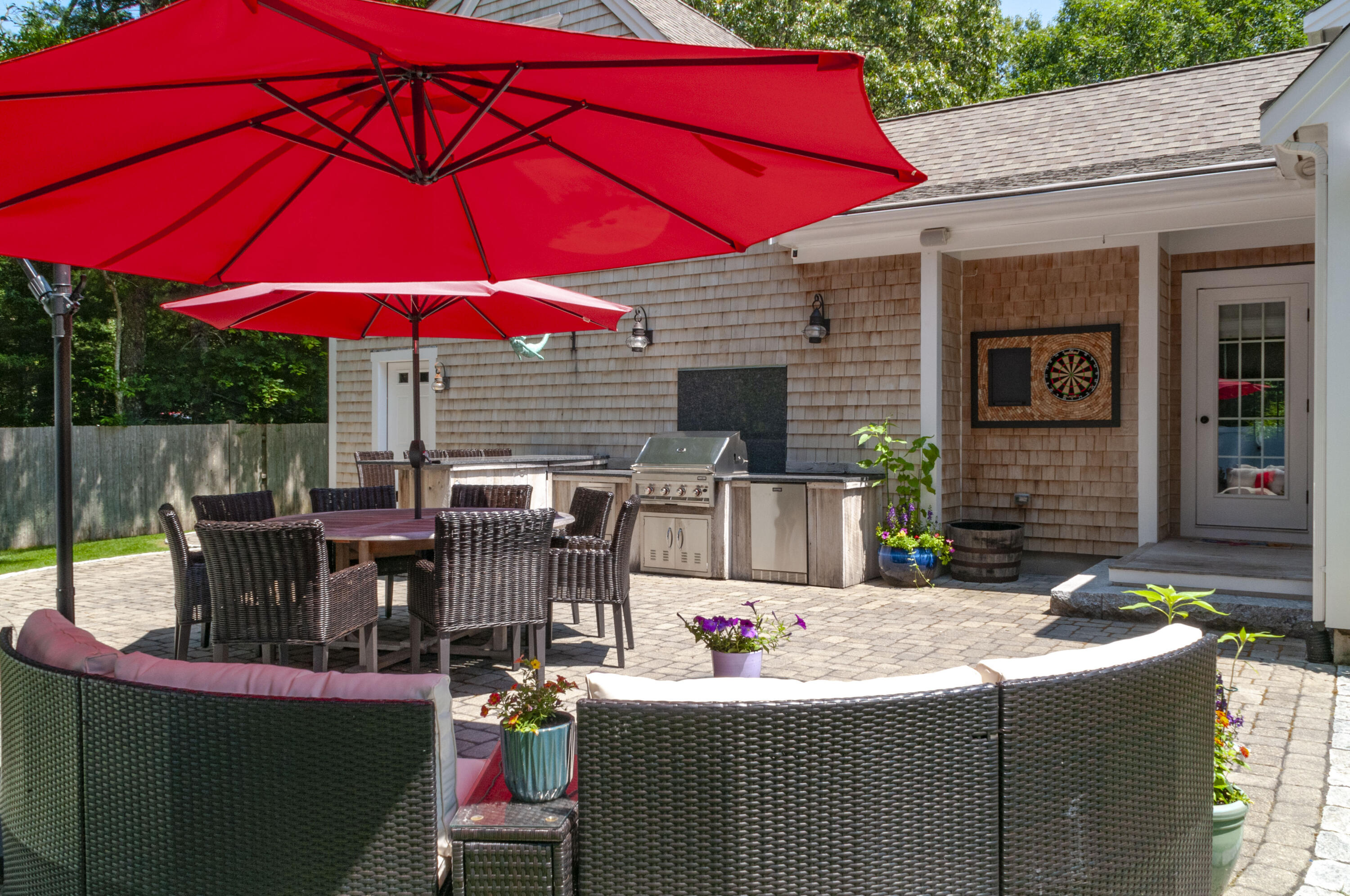 1774 South County Road Osterville, MA 02655 - Photo 12 of 75 a view of a patio with table and chairs under an umbrella