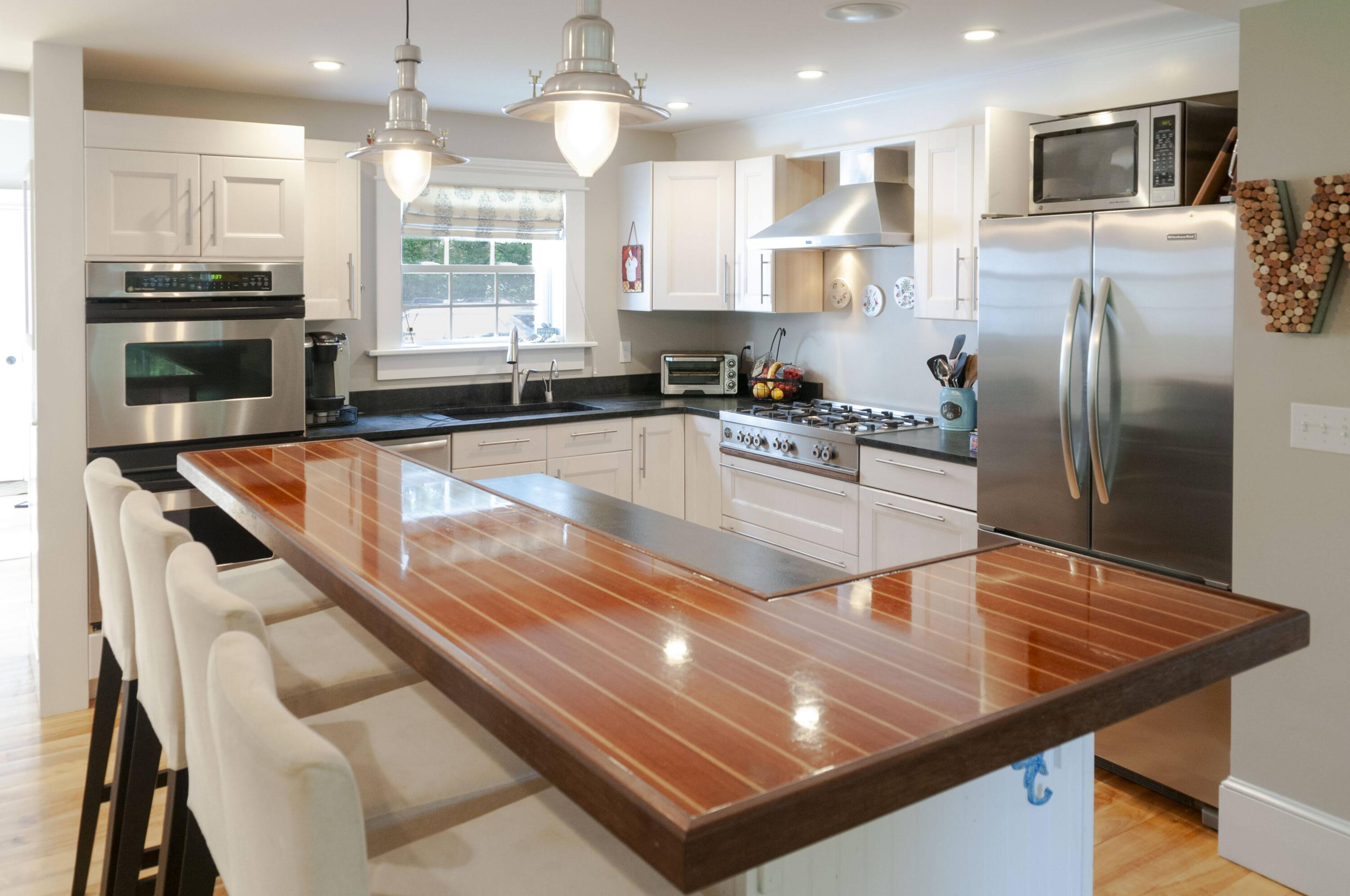 1774 South County Road Osterville, MA 02655 - Photo 25 of 75 a kitchen with stainless steel appliances granite countertop a sink refrigerator and microwave