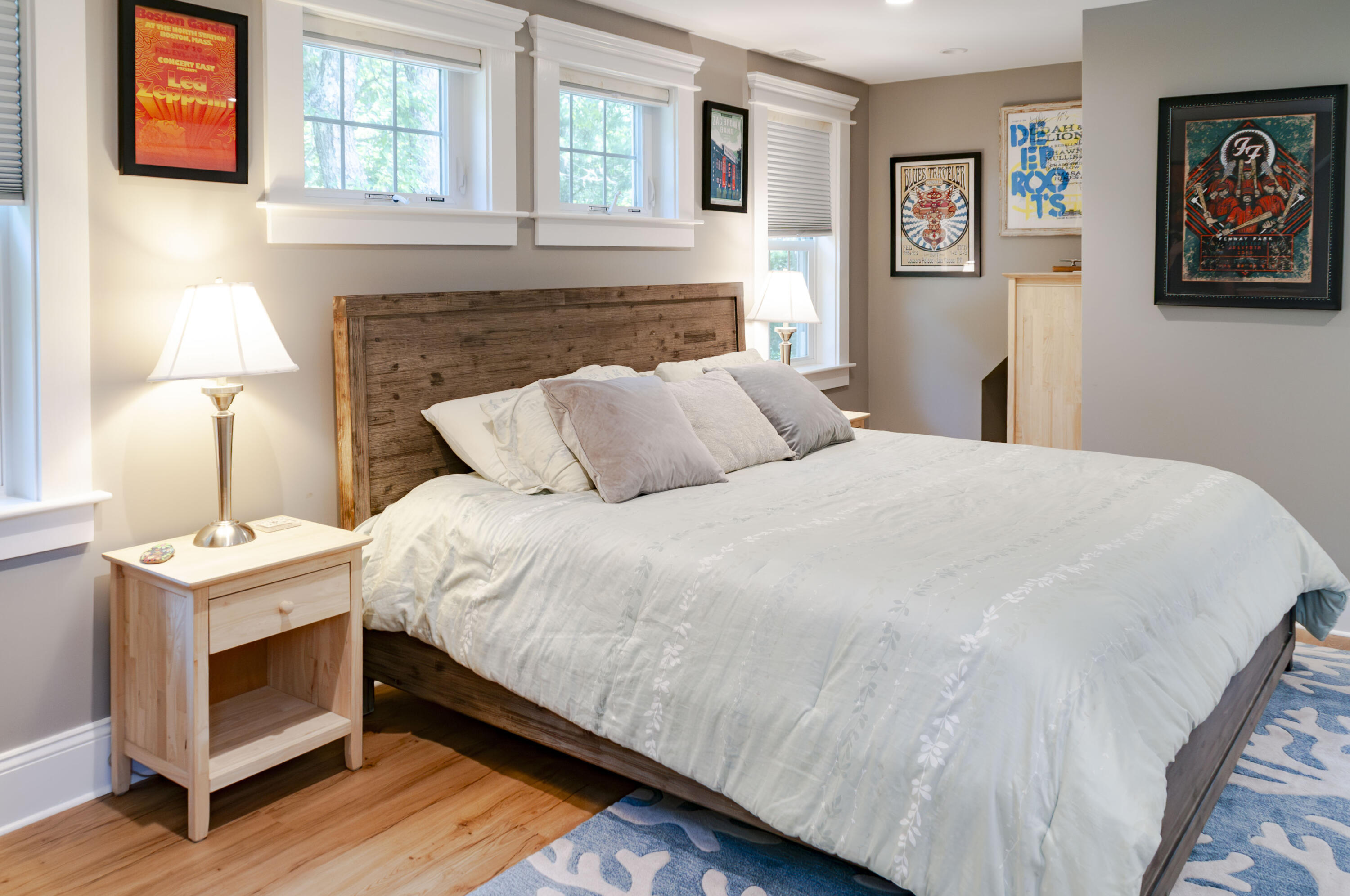 1774 South County Road Osterville, MA 02655 - Photo 68 of 75 a bedroom with a bed and a lamp on dresser with wooden floor