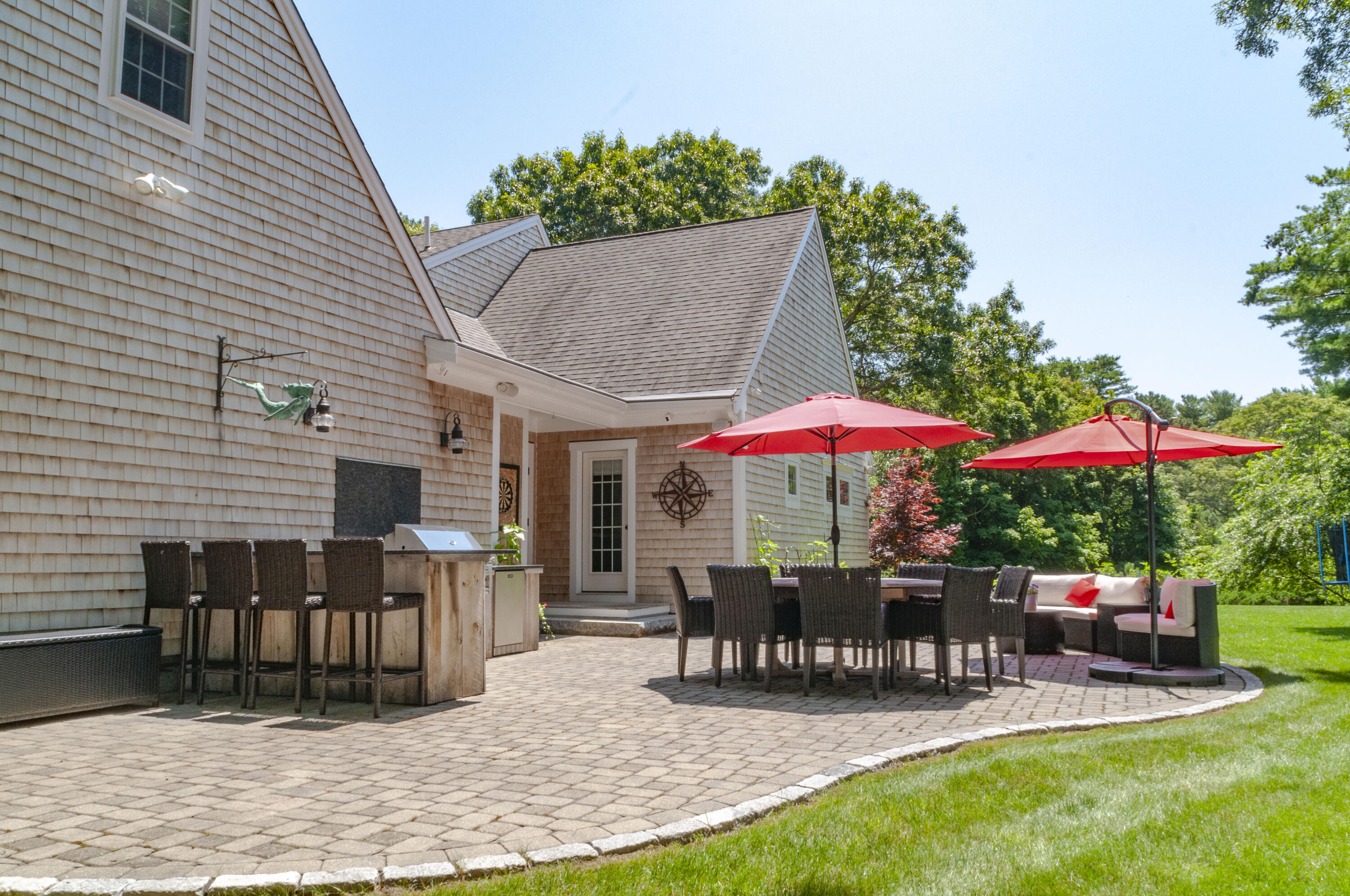 1774 South County Road Osterville, MA 02655 - Photo 10 of 75 a patio with a table and chairs