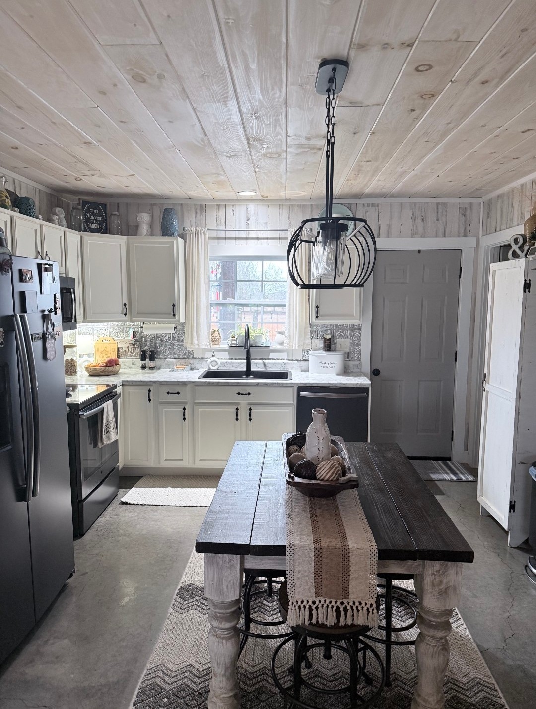 99 Busby Road Loretto, TN 38469 - Photo 12 of 25 a kitchen with stainless steel appliances a stove a sink dishwasher a refrigerator white cabinets and wooden floor