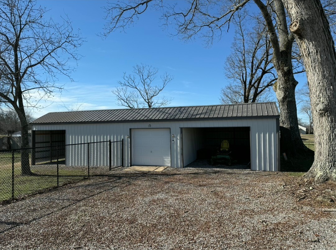 99 Busby Road Loretto, TN 38469 - Photo 20 of 25 a view of a house with a yard and garage