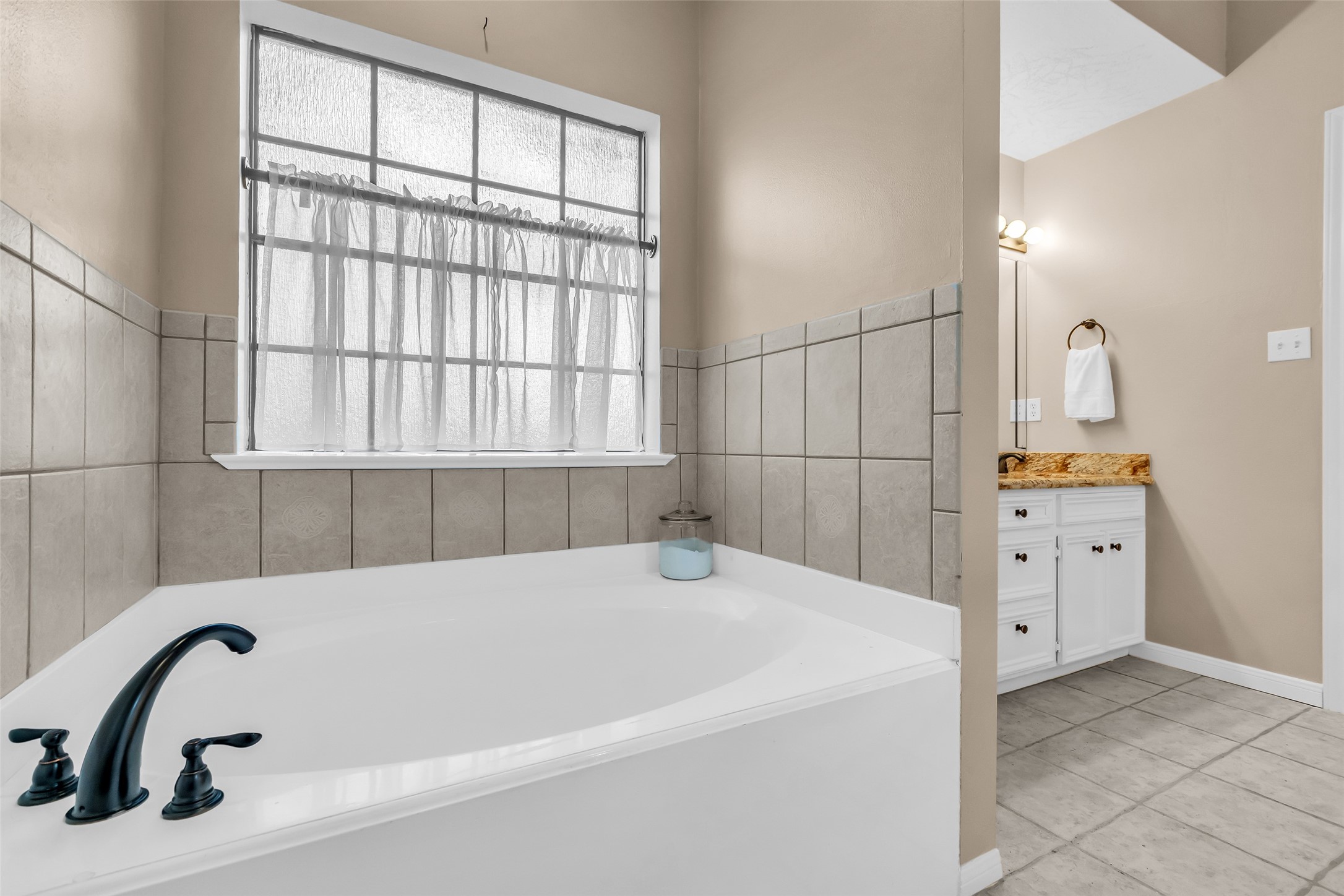 28414 Dobbin-Huffsmith Road Magnolia, TX 77354 - Photo 15 of 39 a bathroom with a bathtub and window