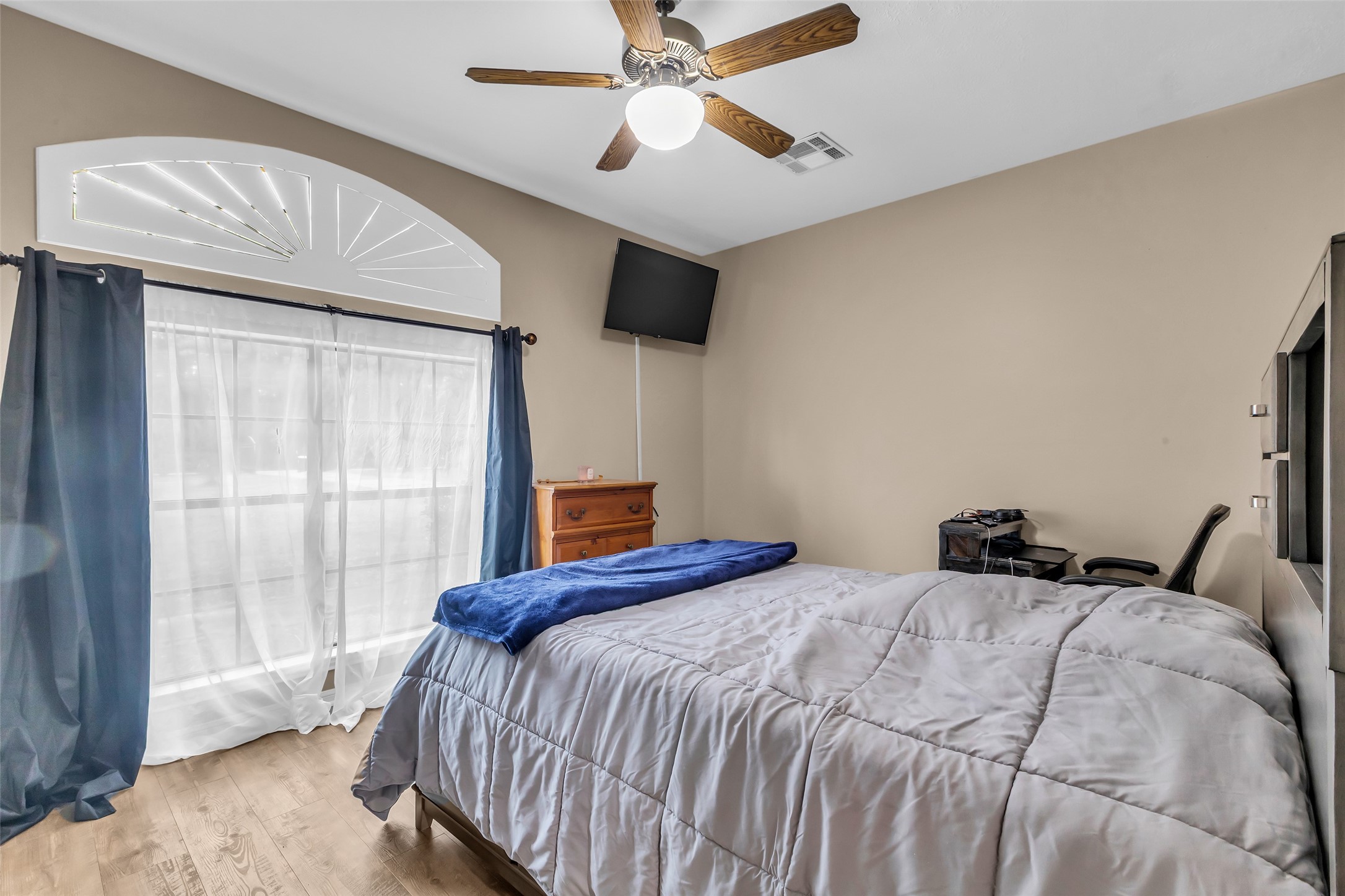 28414 Dobbin-Huffsmith Road Magnolia, TX 77354 - Photo 19 of 39 a bedroom with a bed and a chandelier