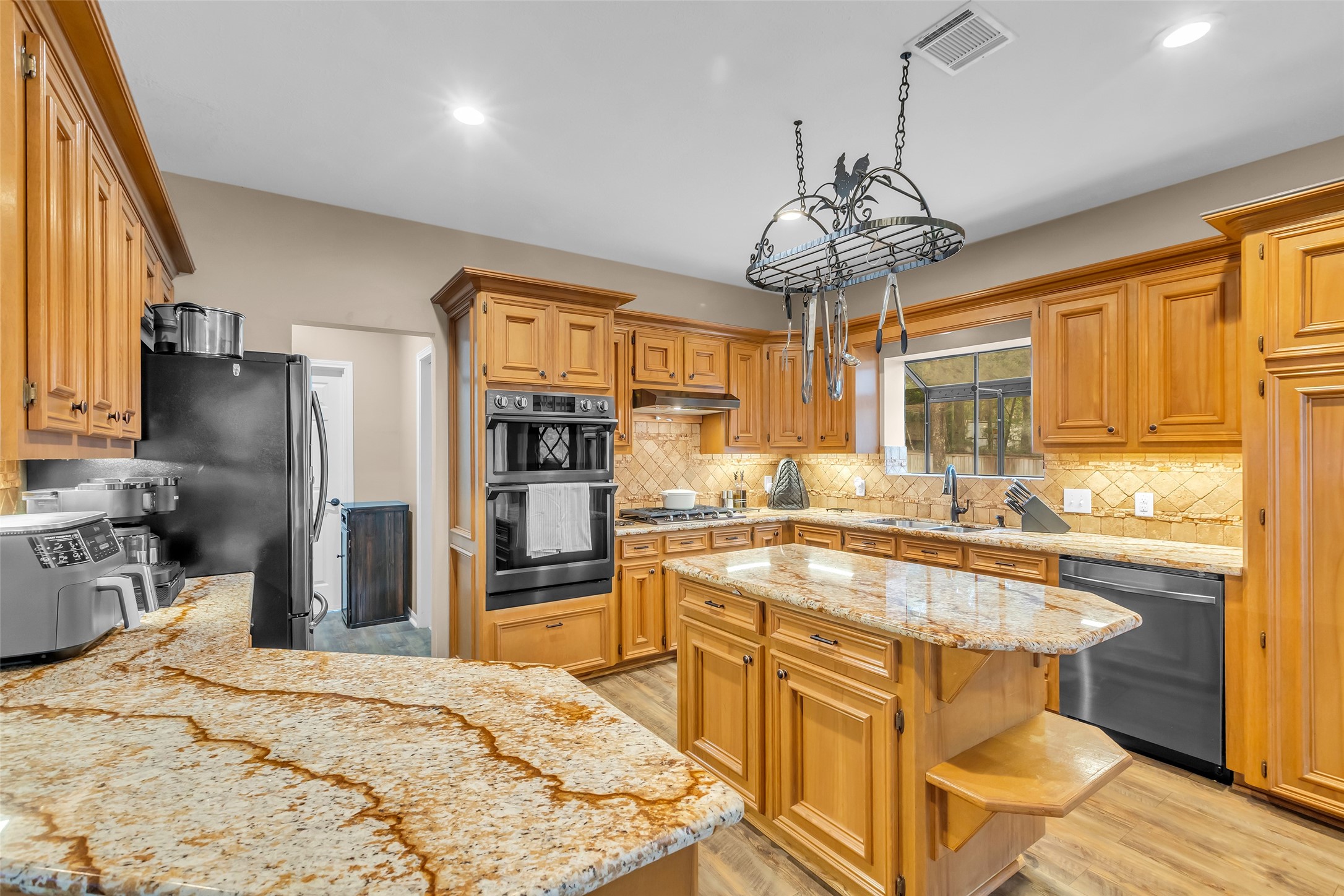 28414 Dobbin-Huffsmith Road Magnolia, TX 77354 - Photo 5 of 39 a kitchen with stainless steel appliances granite countertop a sink stove and refrigerator