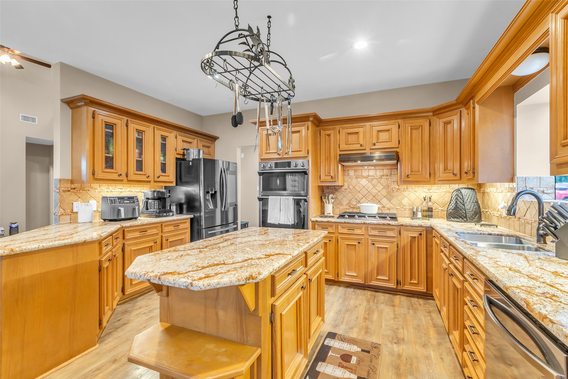 28414 Dobbin-Huffsmith Road Magnolia, TX 77354 - Photo 6 of 39 a kitchen with stainless steel appliances granite countertop a sink stove and refrigerator