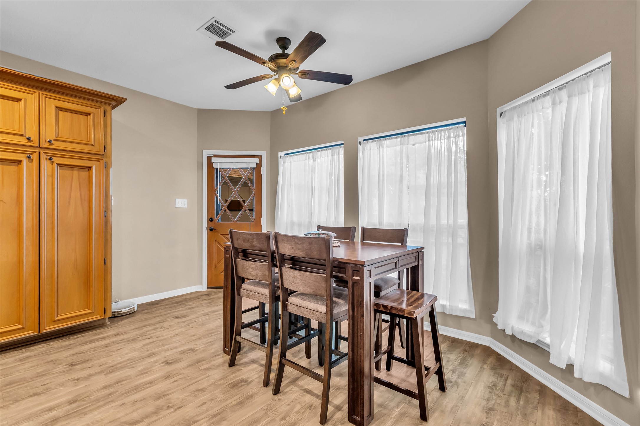 28414 Dobbin-Huffsmith Road Magnolia, TX 77354 - Photo 7 of 39 a view of a dining room with furniture window and wooden floor