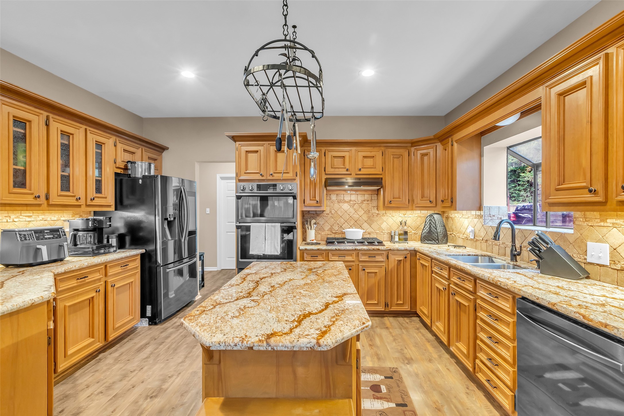 28414 Dobbin-Huffsmith Road Magnolia, TX 77354 - Photo 9 of 39 a kitchen with stainless steel appliances granite countertop a sink stove and refrigerator