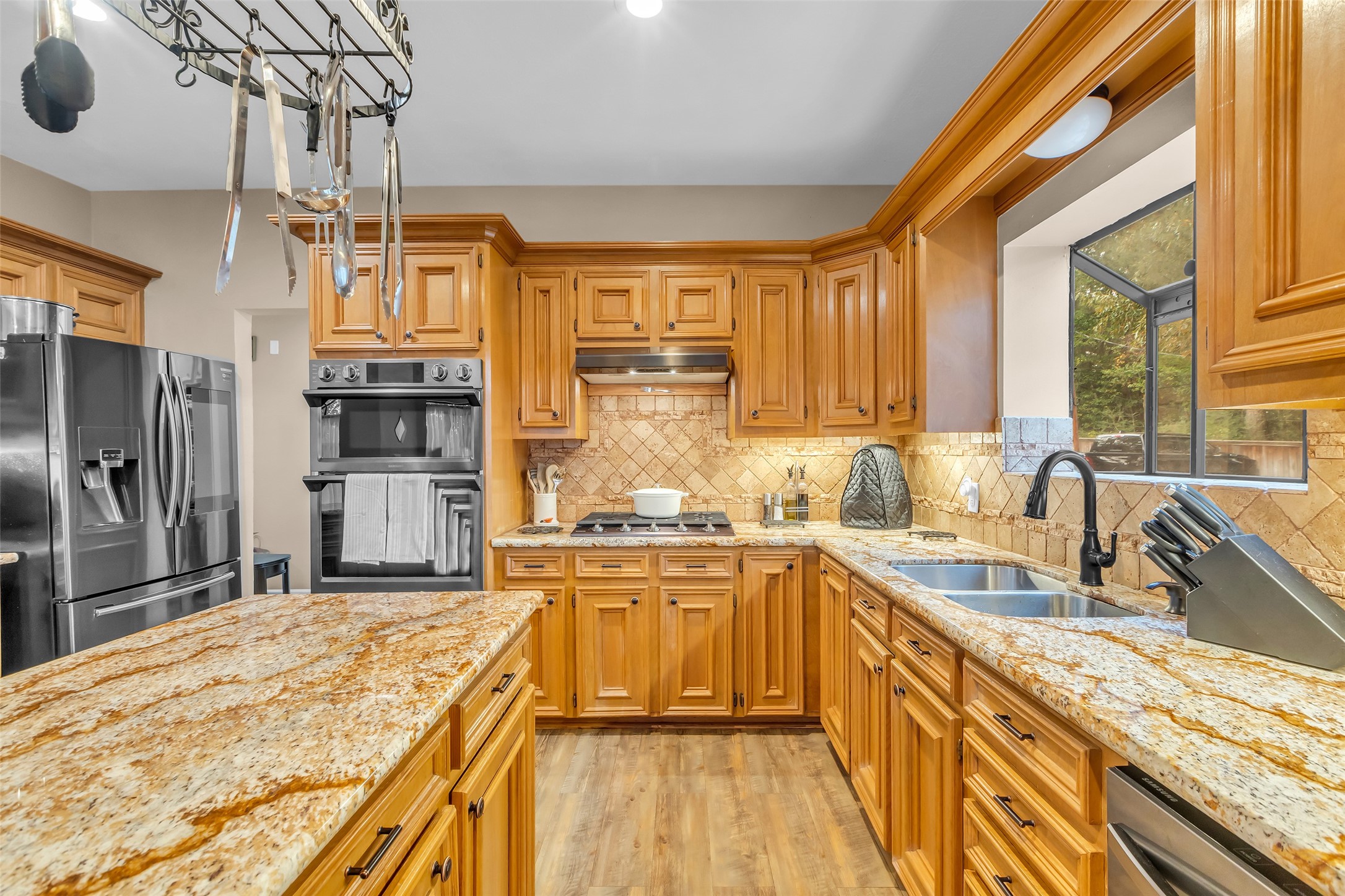28414 Dobbin-Huffsmith Road Magnolia, TX 77354 - Photo 10 of 39 a kitchen with stainless steel appliances granite countertop a sink stove and refrigerator