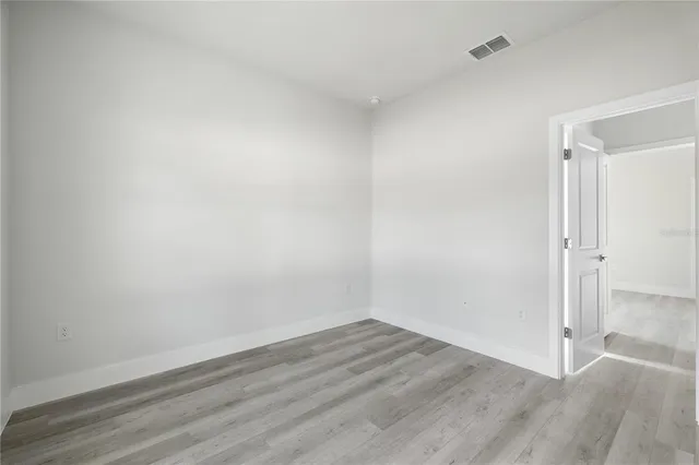 an empty room with wooden floor