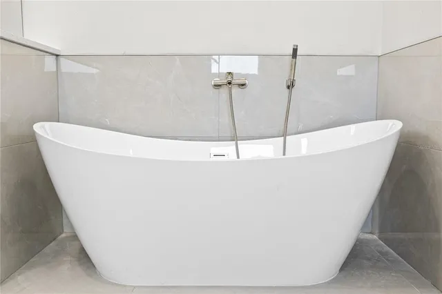 a white bath tub sitting in a bathroom