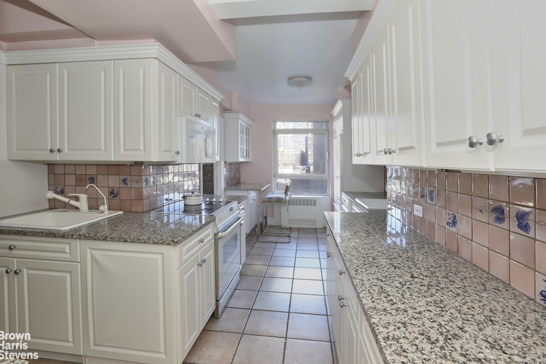 2 Beekman Place, Unit 15/16C Manhattan, NY 10022 - Photo 10 of 18 a kitchen with a sink stove and cabinets