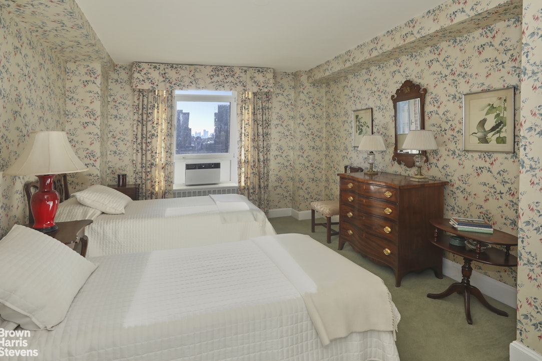 2 Beekman Place, Unit 15/16C Manhattan, NY 10022 - Photo 12 of 18 a bedroom with a bed dresser and window