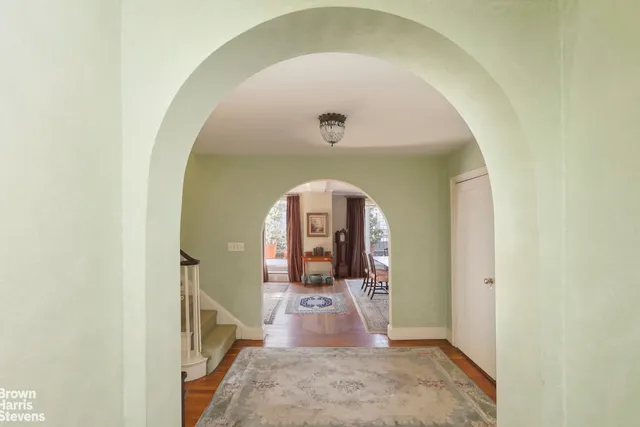 a picture of a living room with a white wall and clock