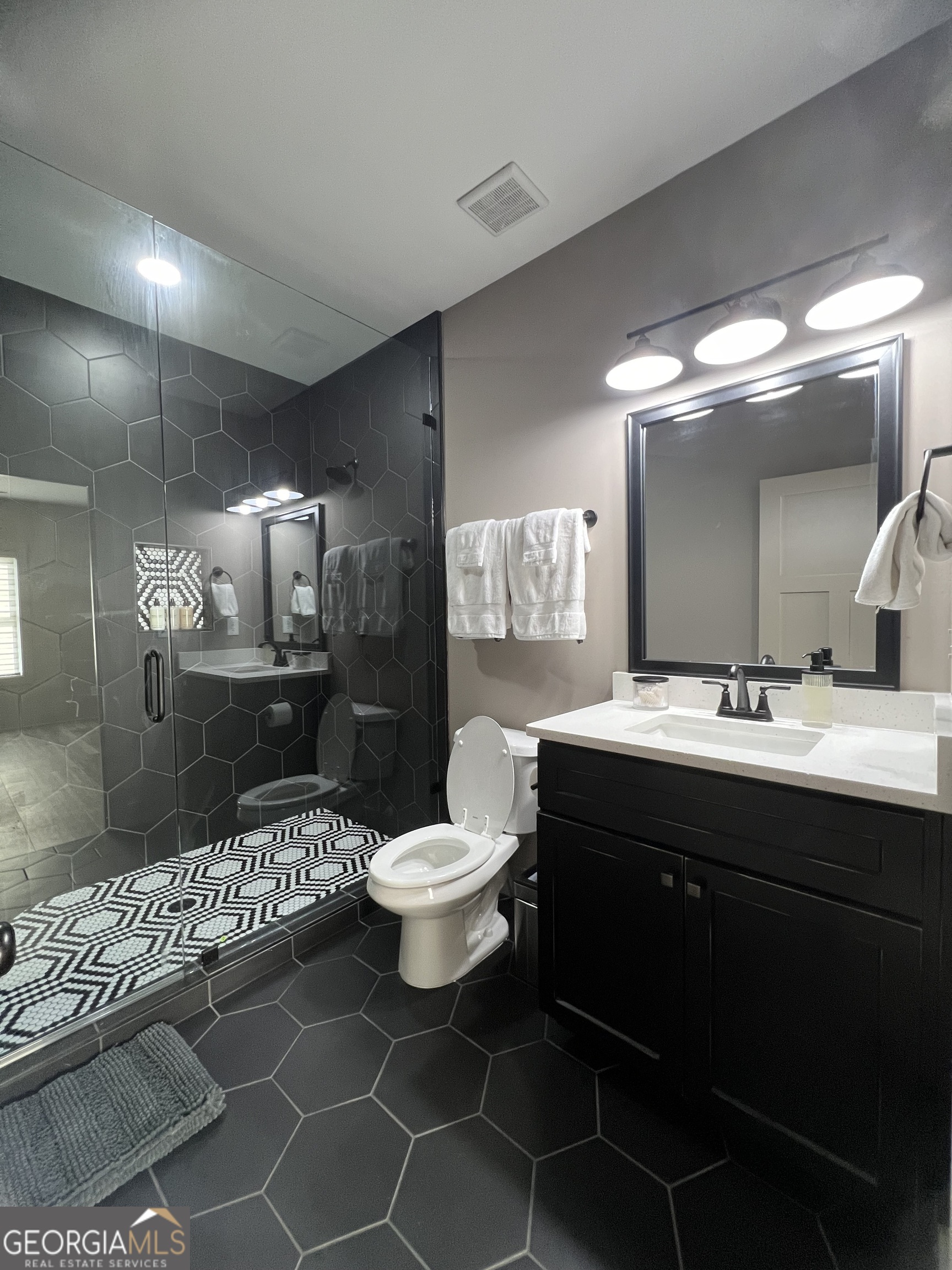 950 Island Shoals Road Jackson, GA 30233 - Photo 13 of 20 a bathroom with a sink toilet and a mirror