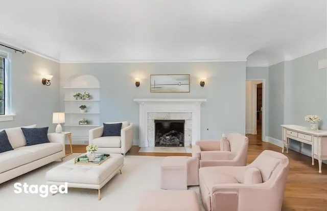 a living room with furniture and a fireplace