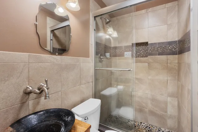 a bathroom with a toilet and a shower
